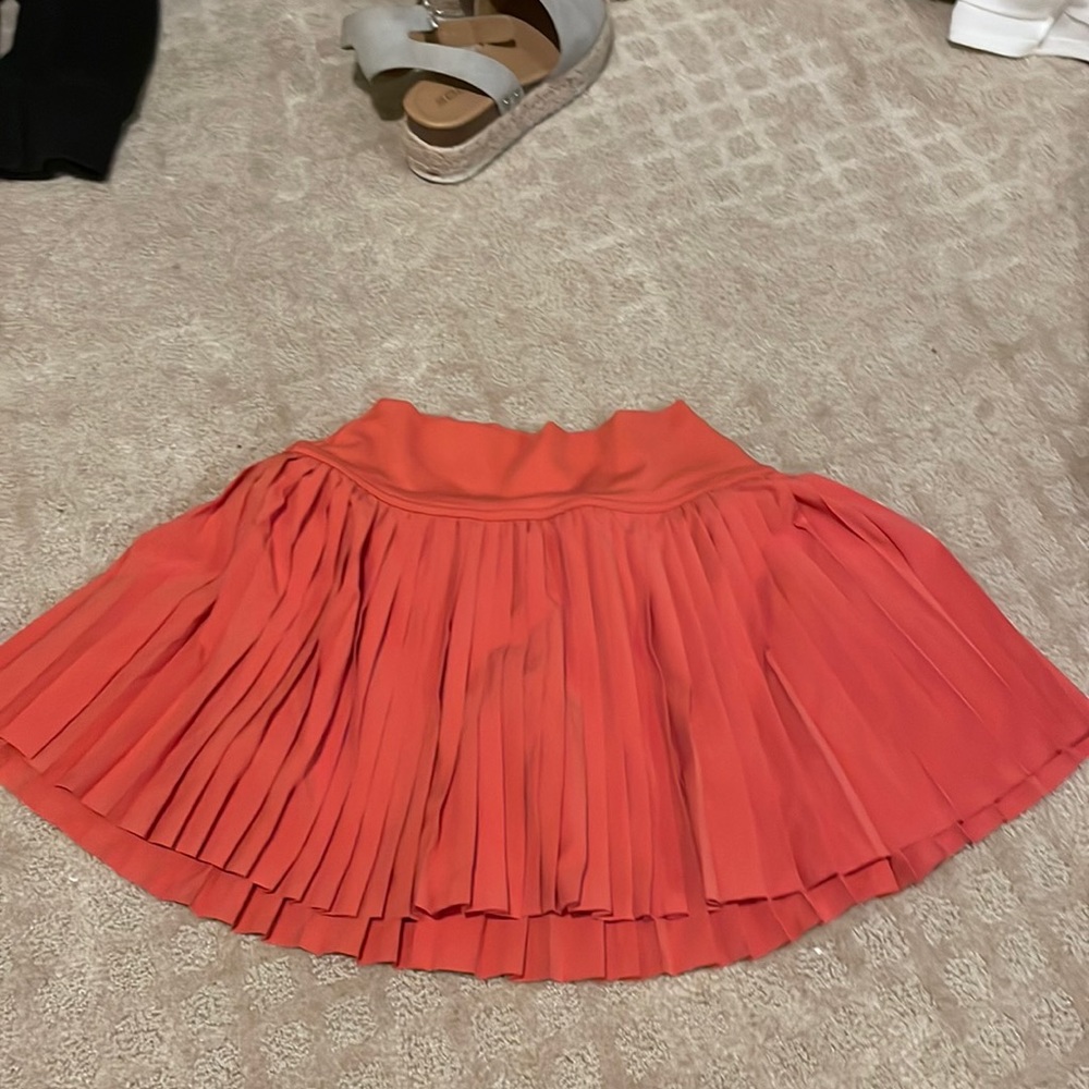orange pleaded skirt